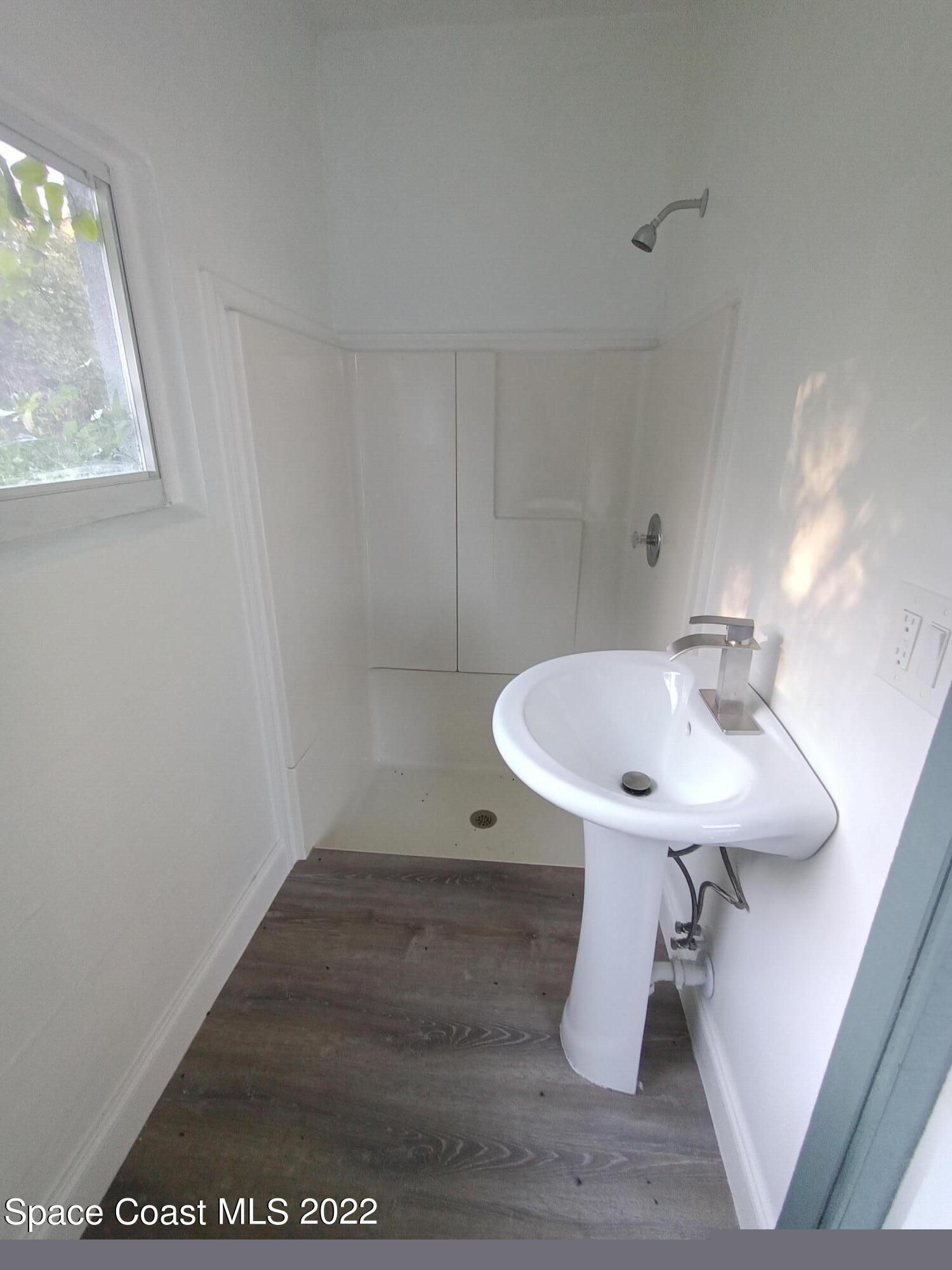 758 Buffalo Road Titusville, FL 32796 - Photo 43 of 52 a bathroom with a sink toilet and a mirror