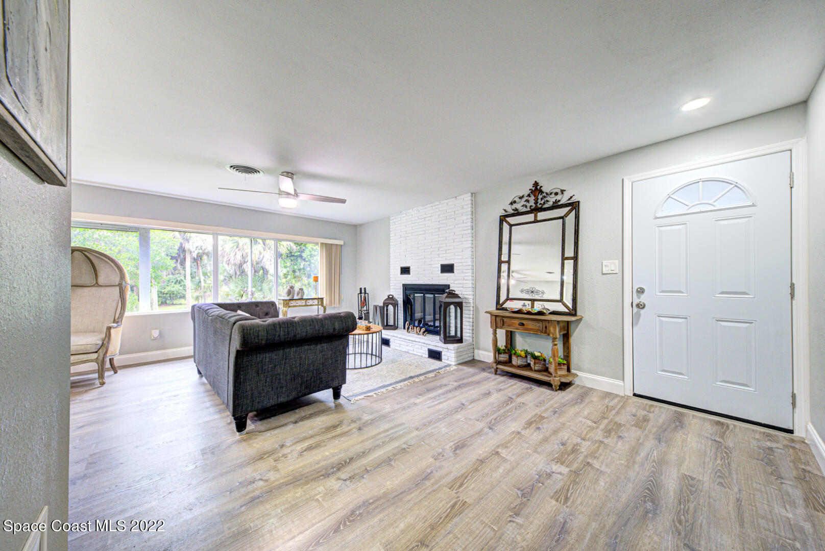 758 Buffalo Road Titusville, FL 32796 - Photo 5 of 52 a living room with furniture and a fireplace