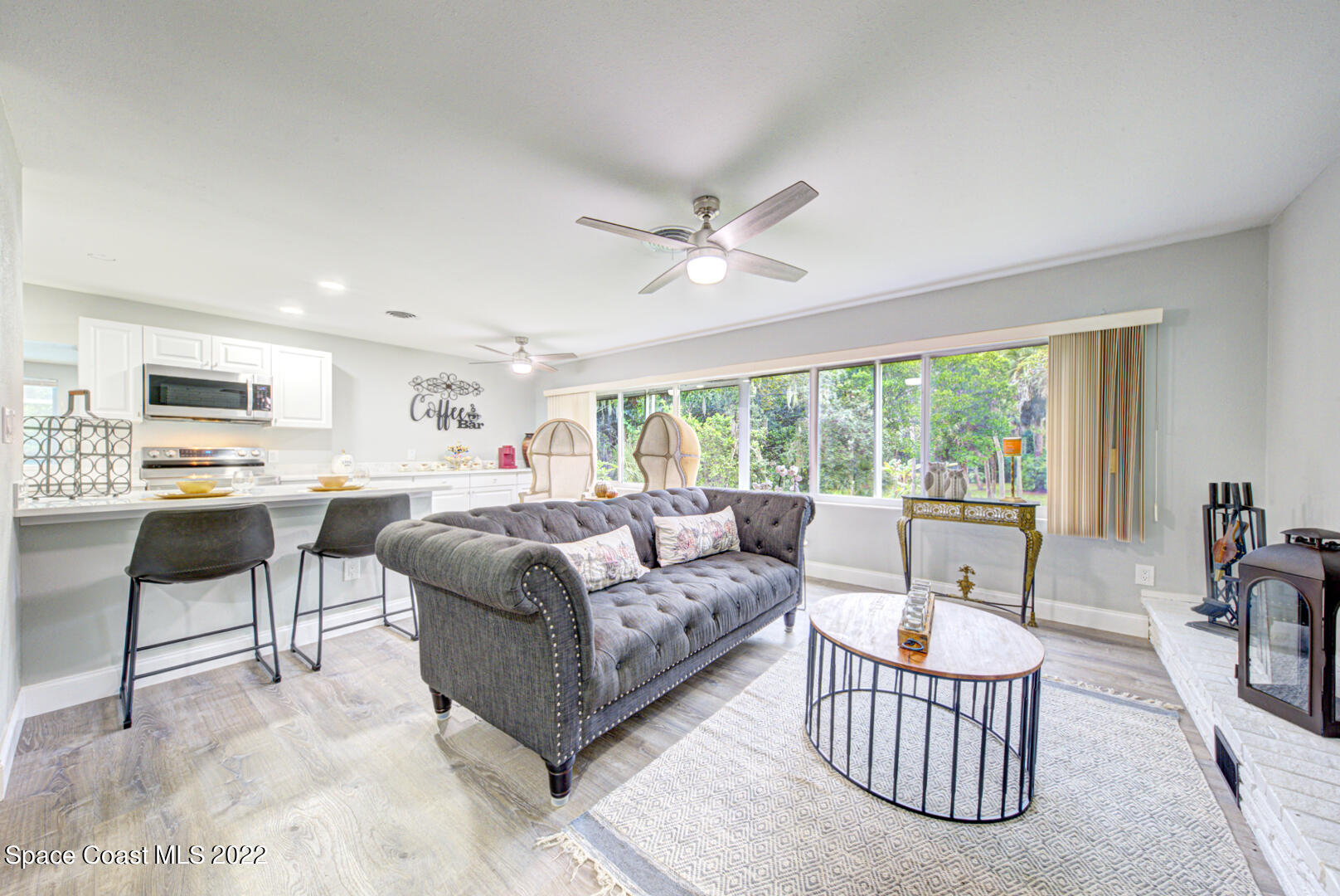 758 Buffalo Road Titusville, FL 32796 - Photo 9 of 52 a living room with furniture and a large window