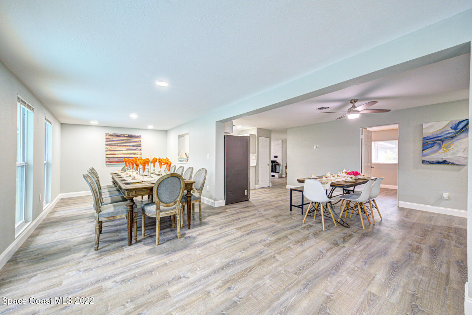 758 Buffalo Road Titusville, FL 32796 - Photo 10 of 52 a dining room with furniture a chandelier and wooden floor