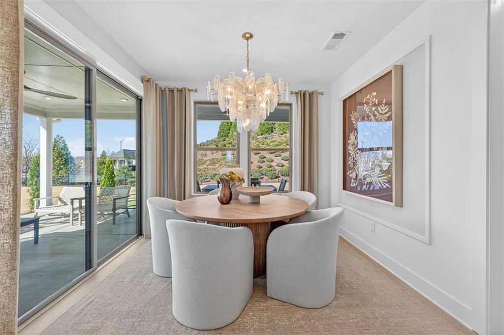 5425 Cordina Road Hoschton, GA 30548 - Photo 13 of 30 a dining room with chandelier large windows