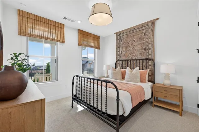 a bedroom with a bed and a painting on the wall