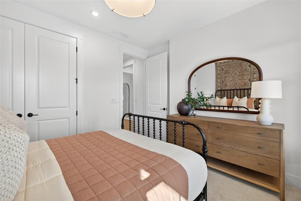 5425 Cordina Road Hoschton, GA 30548 - Photo 17 of 30 a bedroom with a bed and a dresser