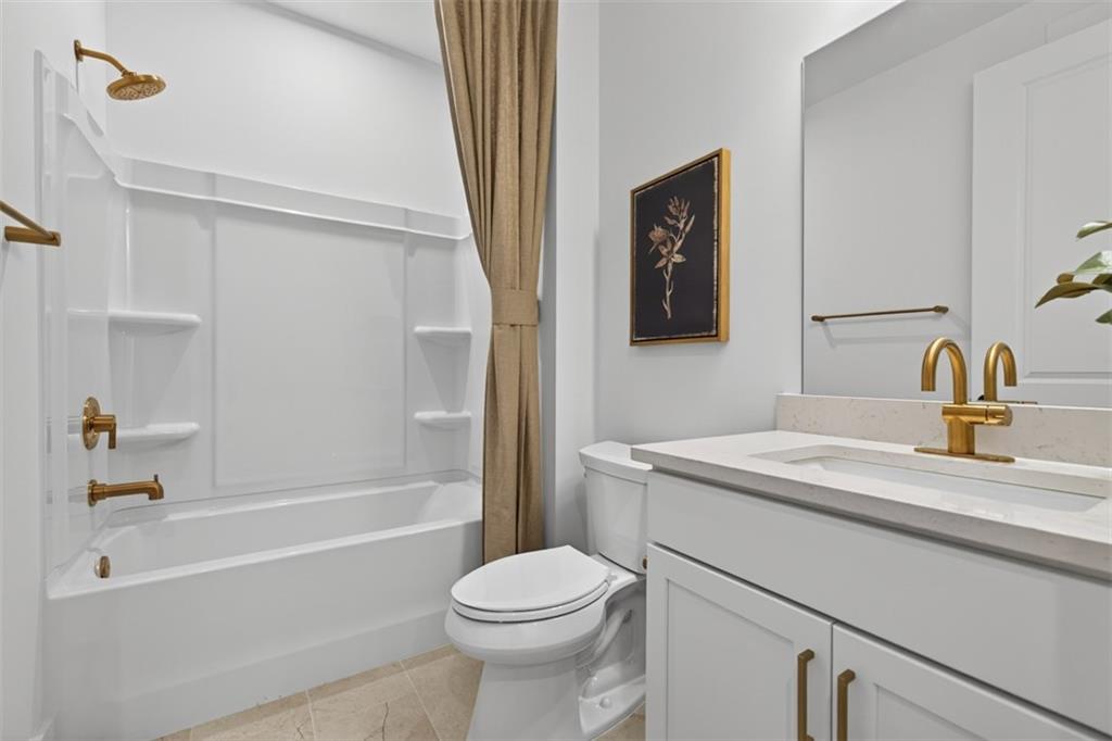 5425 Cordina Road Hoschton, GA 30548 - Photo 18 of 30 a bathroom with a sink a toilet and a bathtub