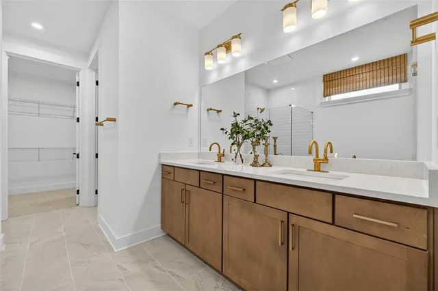 a bathroom with a sink a mirror and a shower