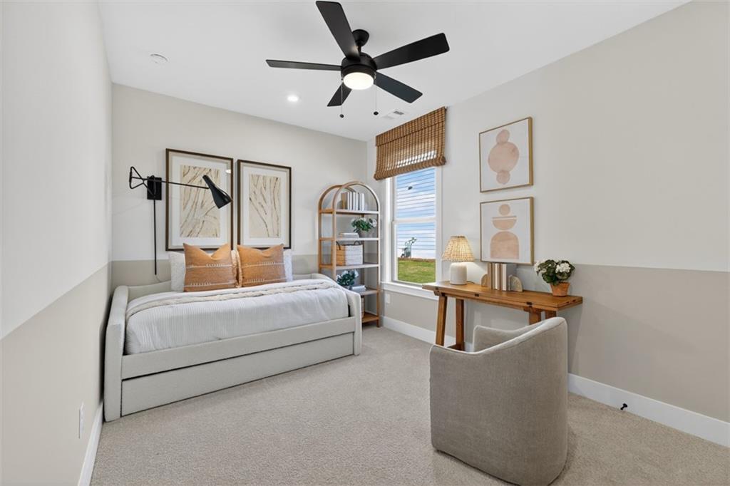 5425 Cordina Road Hoschton, GA 30548 - Photo 21 of 30 a bedroom with a bed and a chandelier