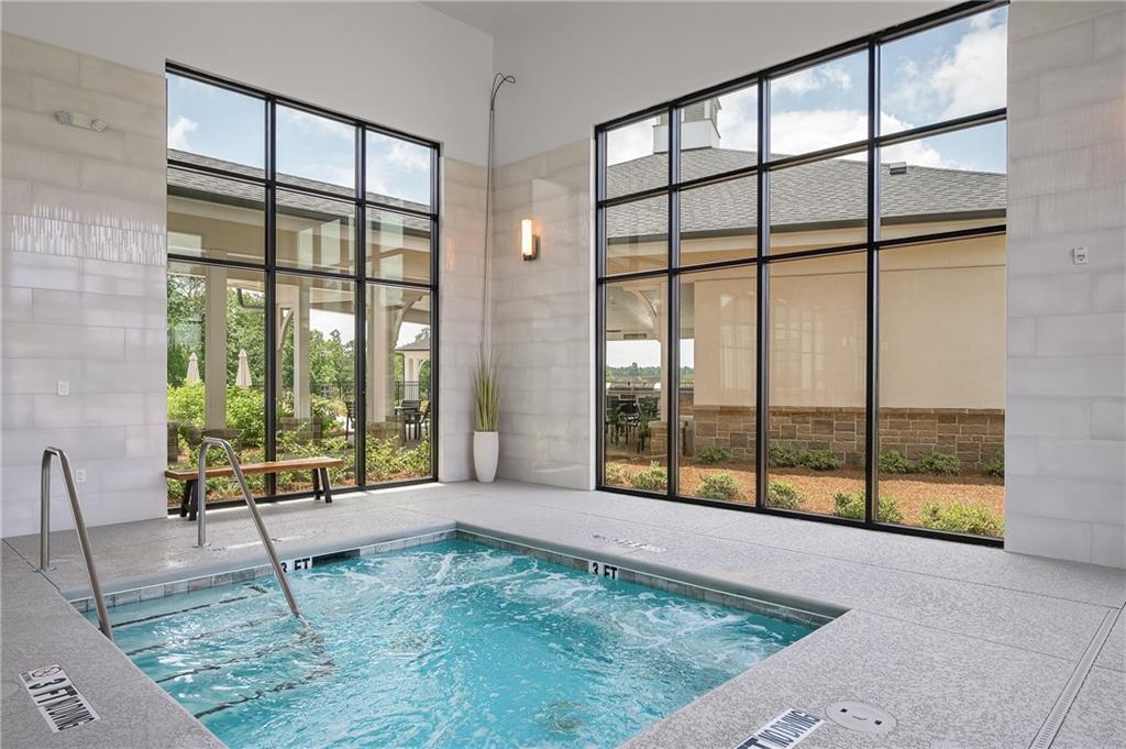 5425 Cordina Road Hoschton, GA 30548 - Photo 25 of 30 a view of an empty room with a floor to ceiling window and a table