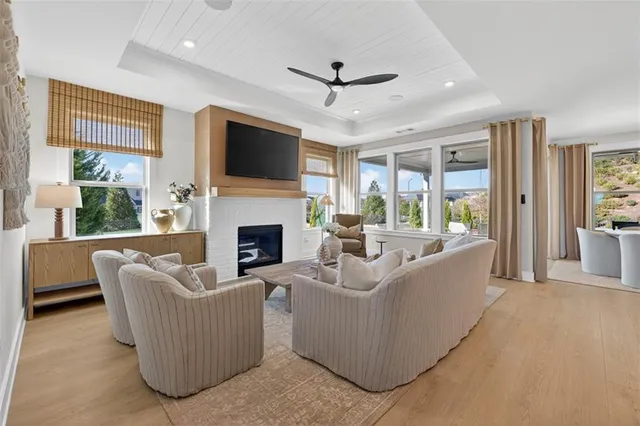 a living room with furniture a flat screen tv and a fireplace