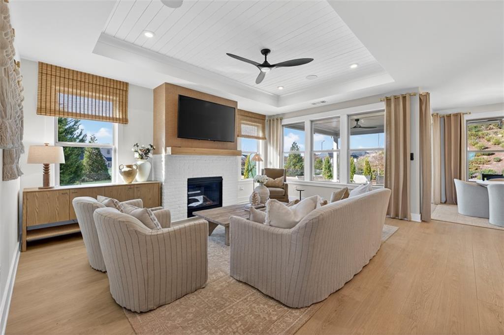5425 Cordina Road Hoschton, GA 30548 - Photo 5 of 30 a living room with furniture a flat screen tv and a fireplace