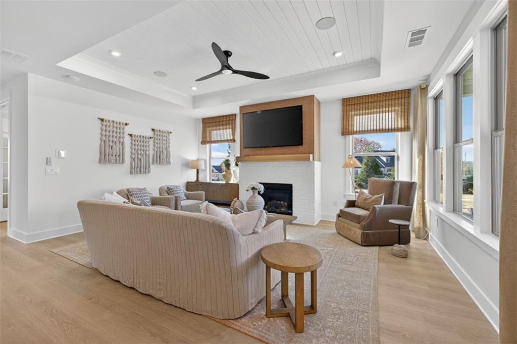 5425 Cordina Road Hoschton, GA 30548 - Photo 6 of 30 a living room with furniture fireplace and a flat screen tv