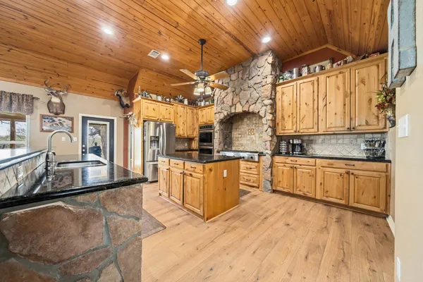 a bedroom with a large bed and a chandelier