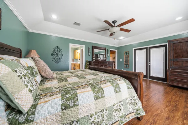 a large white kitchen with a sink a window and stainless steel appliances