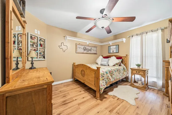a bedroom with bed and wooden floor