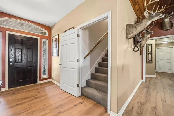 a view of a porch with chairs and a yard