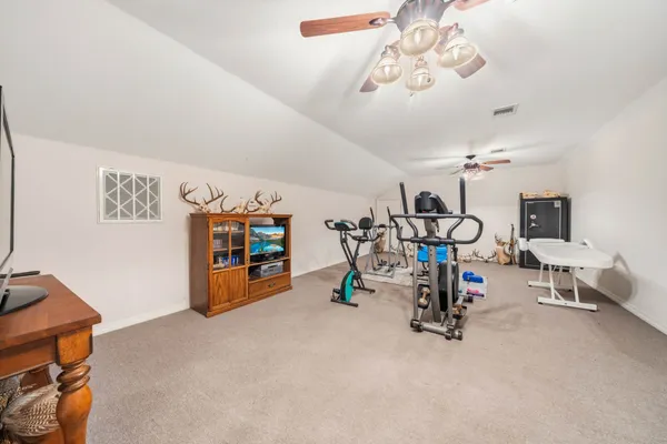 a aerial view of a house with a yard and large trees