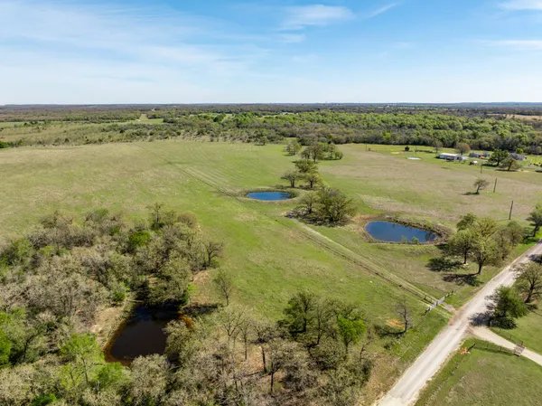 a view of wooden floor and a table in a room
