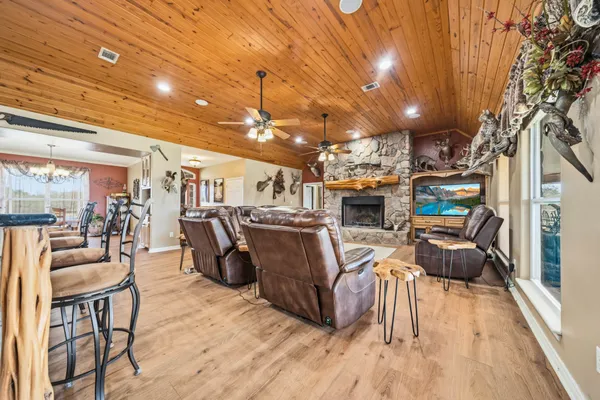 a kitchen with stainless steel appliances kitchen island granite countertop a table and chairs in it