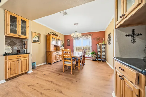 a kitchen with stainless steel appliances granite countertop a sink a stove cabinets and wooden floor