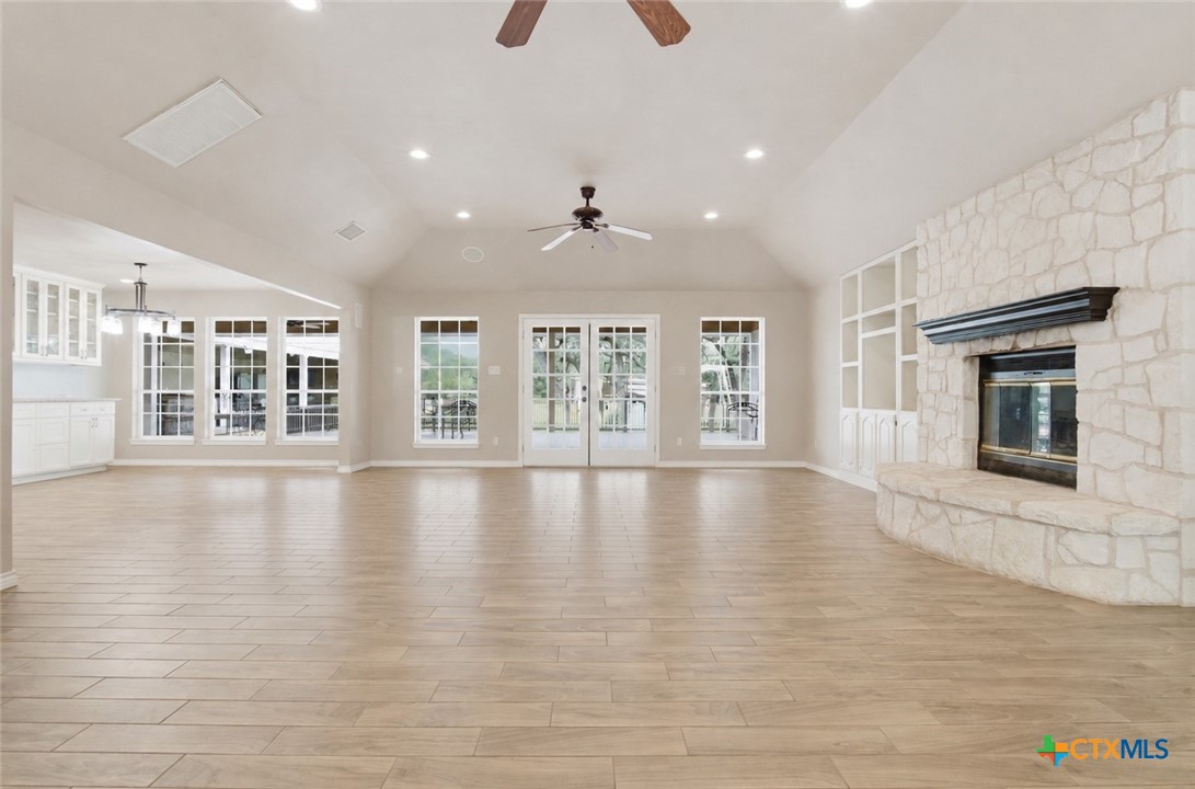642 Phantom Rider Trail Spring Branch, TX 78070 - Photo 6 of 41 a view of an empty room with wooden floor and a window