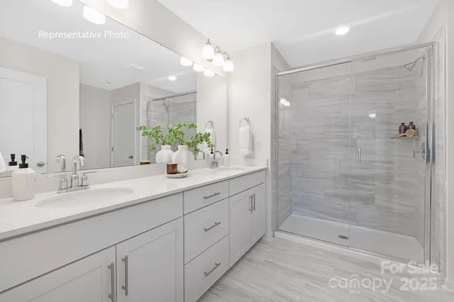 a bathroom with double sink and a mirror