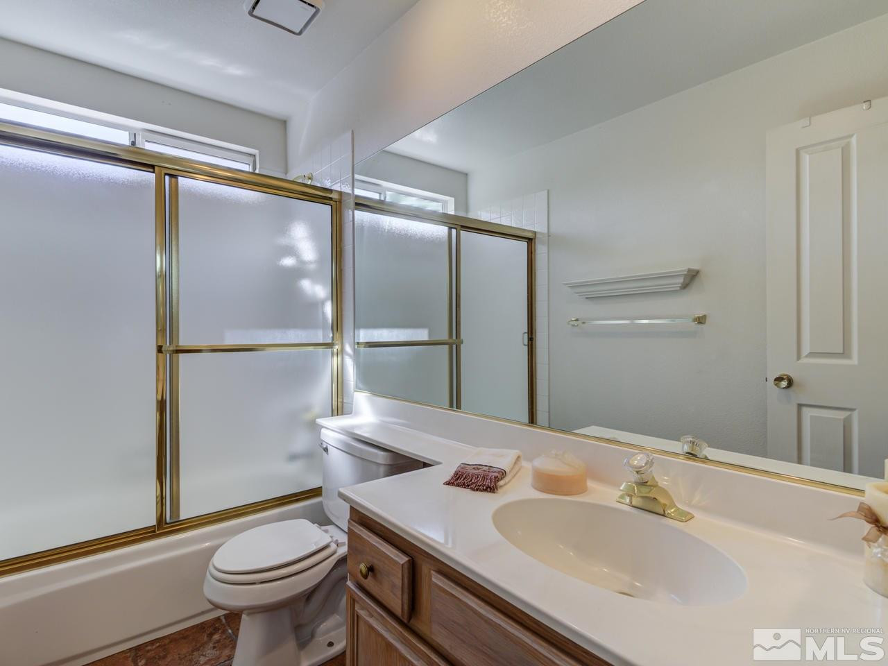 2989 Regal Court Reno, NV 89503 - Photo 11 of 13 a bathroom with a sink toilet and a mirror