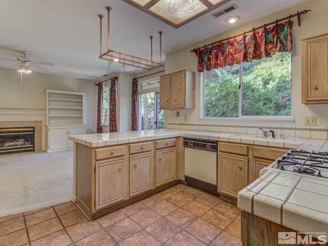 2989 Regal Court Reno, NV 89503 - Photo 4 of 13 a kitchen with stainless steel appliances granite countertop a sink a stove a refrigerator and cabinets