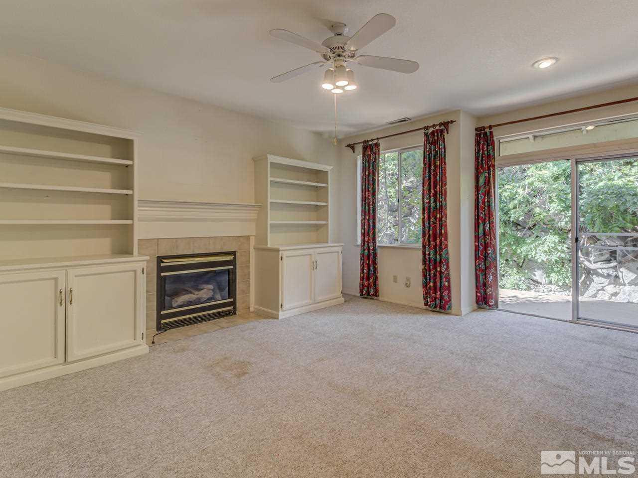 2989 Regal Court Reno, NV 89503 - Photo 6 of 13 a view of an empty room with a fireplace and a window