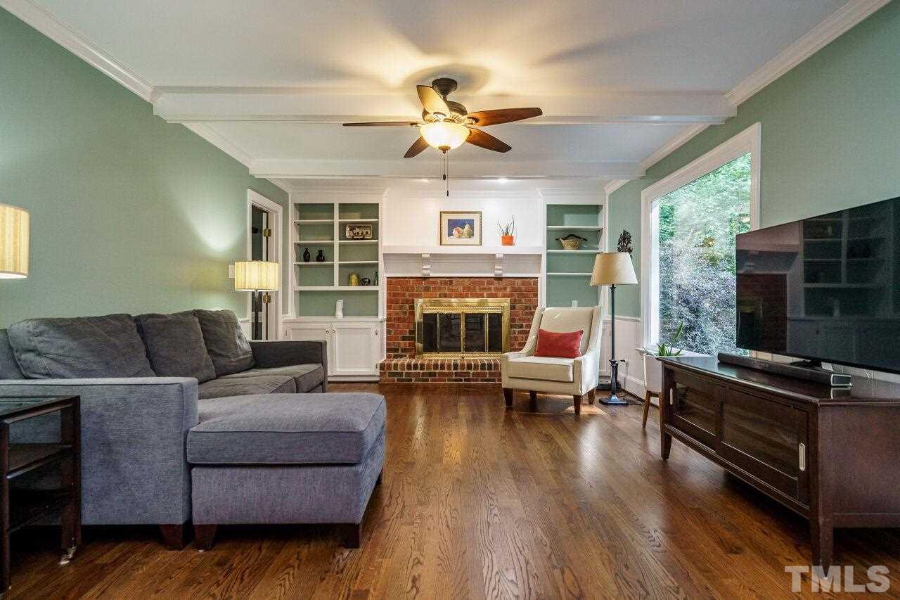 11000 Coachmans Way Raleigh, NC 27614 - Photo 7 of 30 Spacious Family Room with fireplace, gas logs, bookshelves, ceiling beams, ceiling fan, new french doors with retractable screens and hardwood floors.