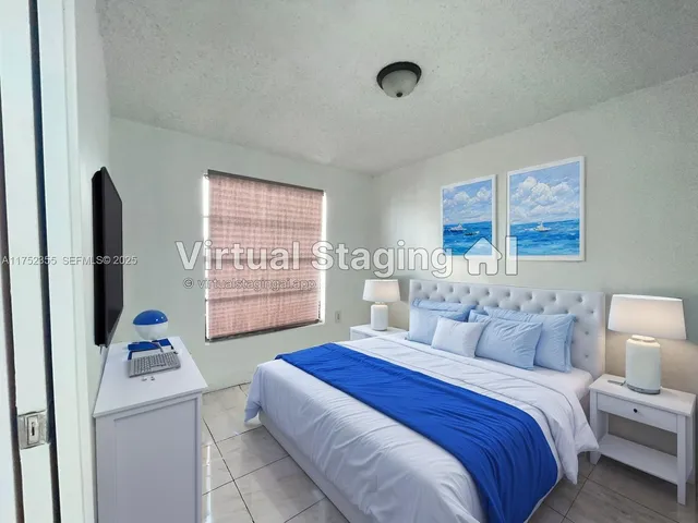 a bedroom with a bed and a refrigerator