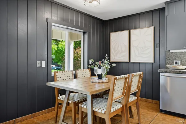 a dining room with furniture and window