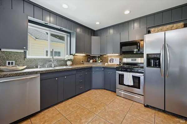 a kitchen with a sink stove and refrigerator
