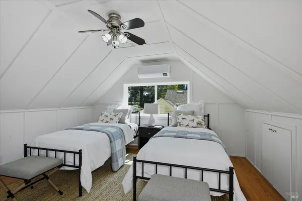 a bedroom with two beds and a chandelier