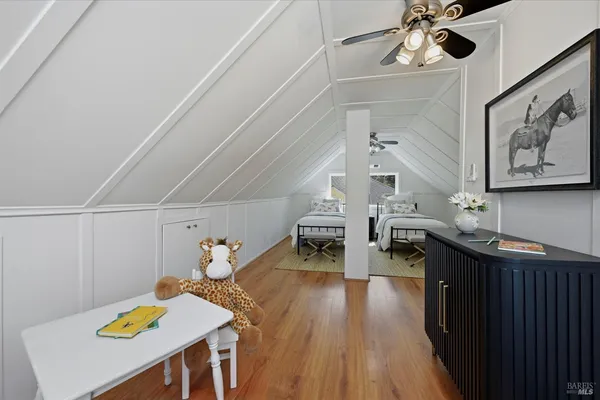 a living room with chairs and kitchen view