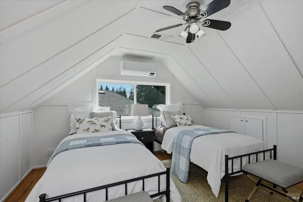a bedroom with two beds and a chandelier