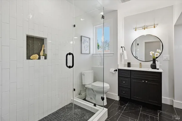 a bathroom with a sink toilet and shower