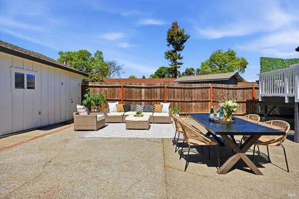 a view of a chairs and table in patio