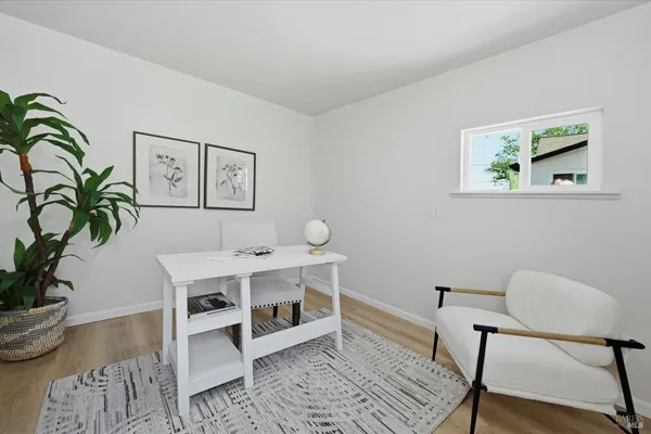 a view of a workspace with furniture and wooden floor