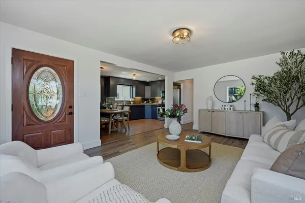 a living room with furniture a clock and a large mirror
