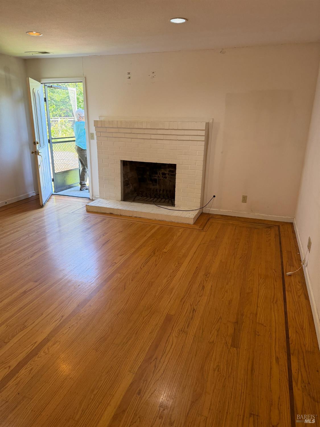 1927 Marsh Road Santa Rosa, CA 95403 - Photo 13 of 29 a view of empty room with wooden floor and fireplace
