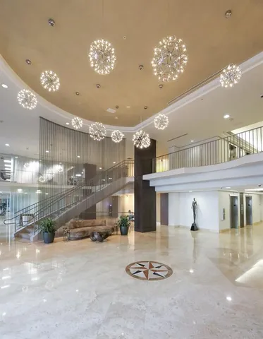 a living room with furniture and floor to ceiling window