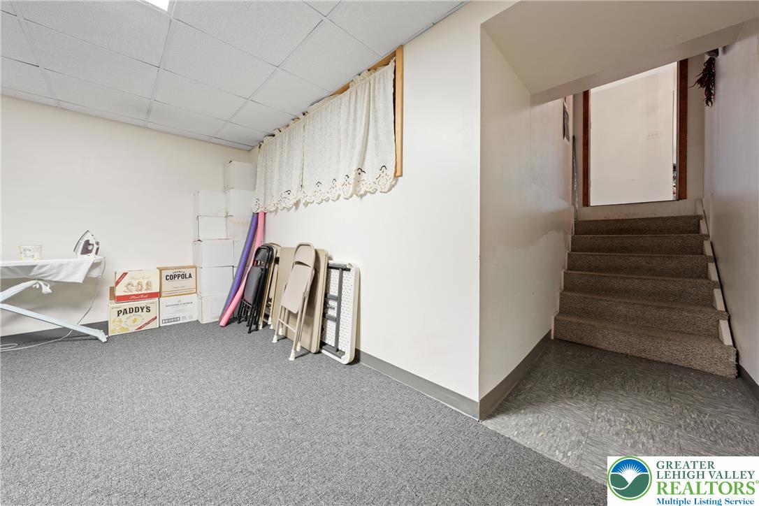 947 Tamenend Road Bath, PA 18014 - Photo 29 of 61 Functional basement space with mixed flooring and convenient staircase access.