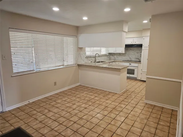 a kitchen with a sink cabinets and window