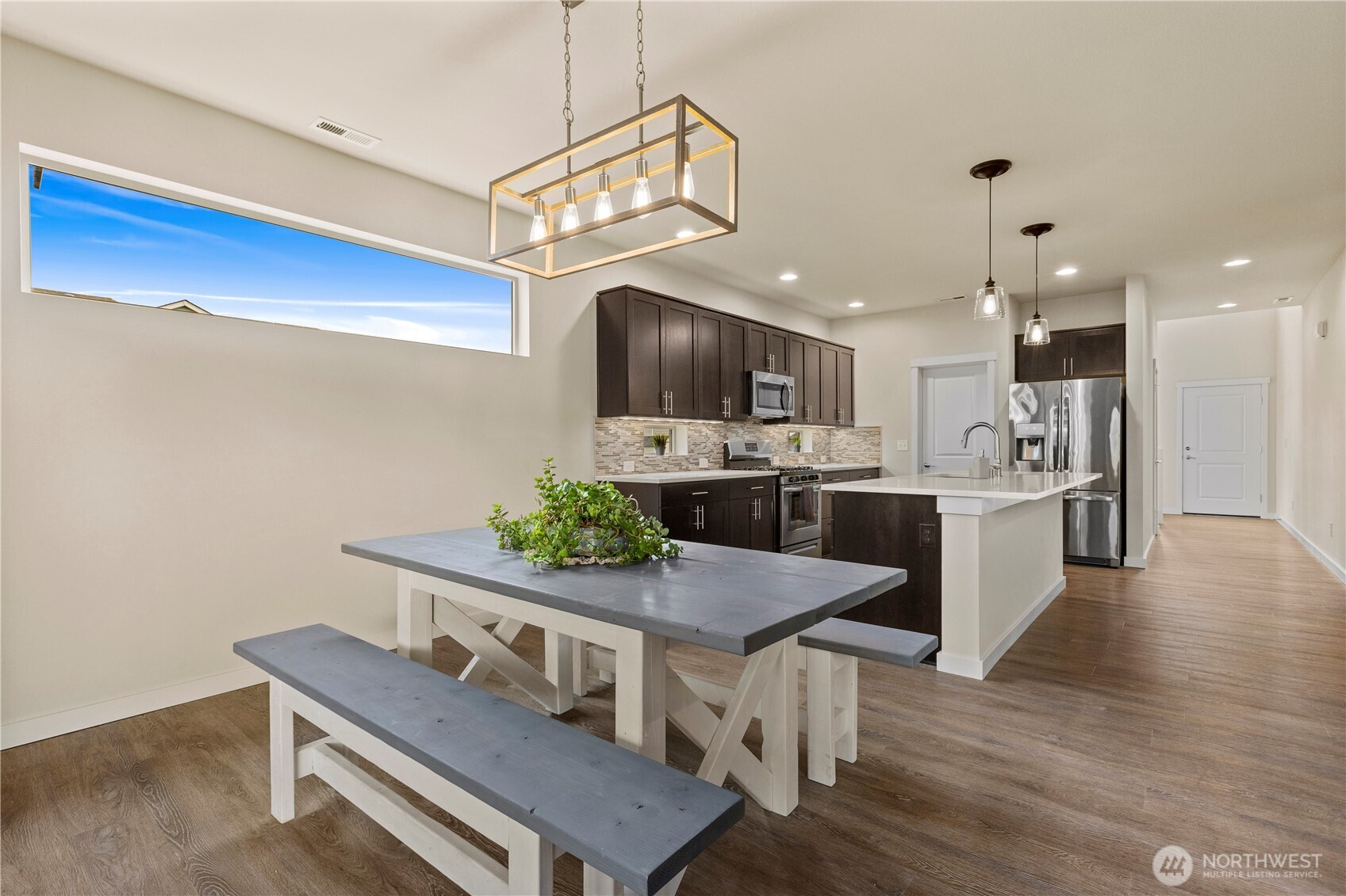 396 South Sergeant Street Buckley, WA 98321 - Photo 12 of 39 a kitchen with stainless steel appliances a dining table chairs stove and refrigerator