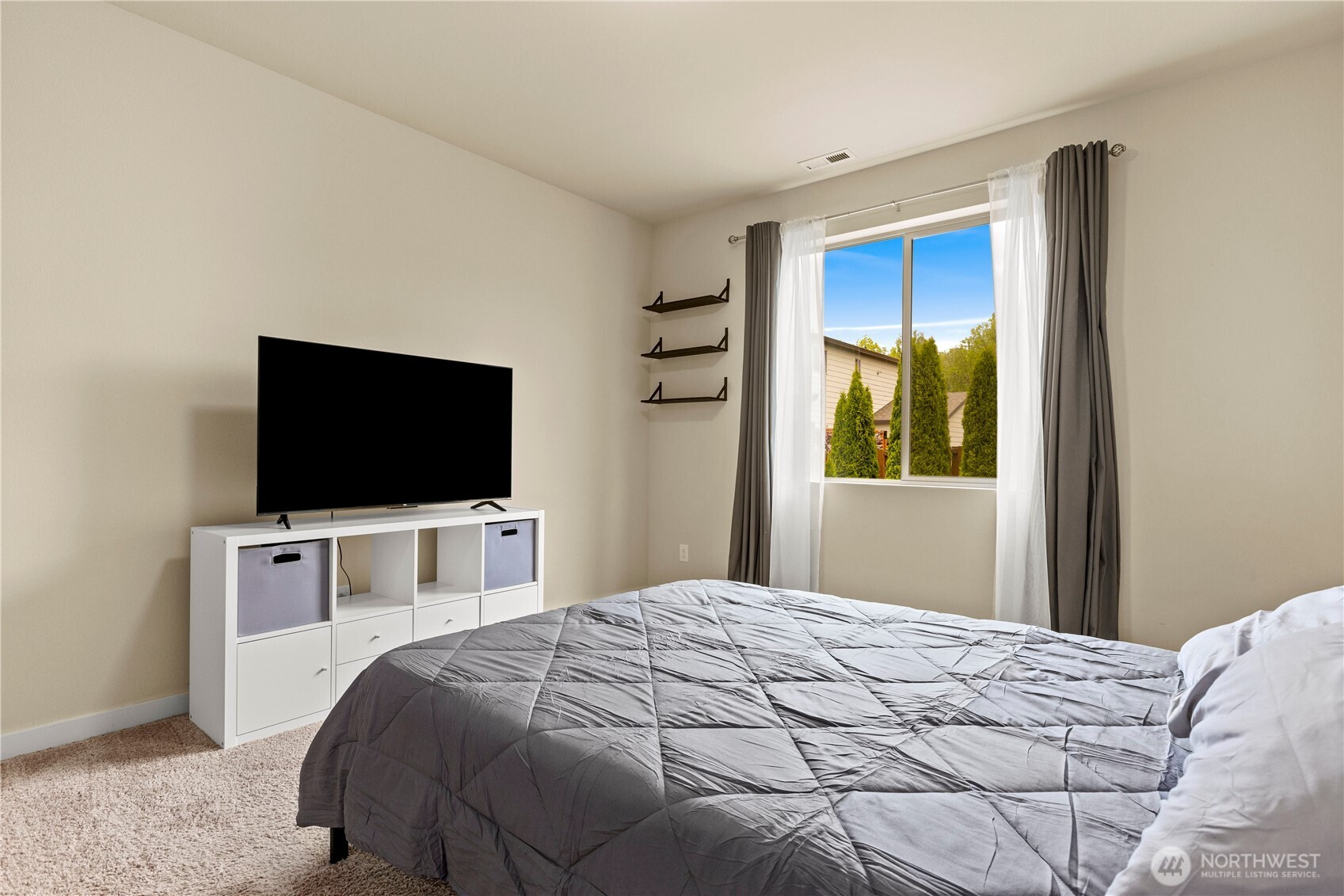 396 South Sergeant Street Buckley, WA 98321 - Photo 14 of 39 a bedroom with a bed and a flat screen tv