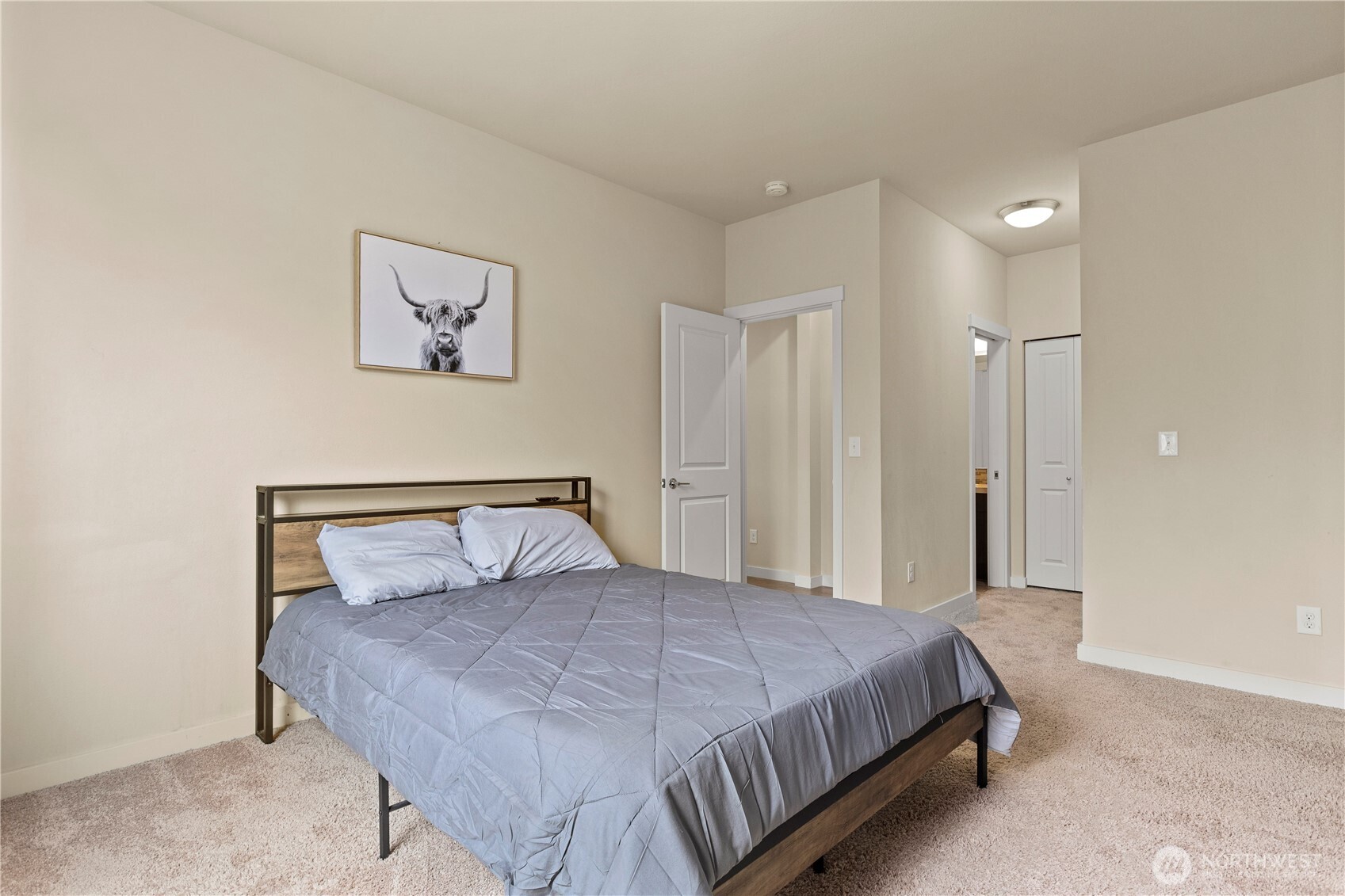 396 South Sergeant Street Buckley, WA 98321 - Photo 16 of 39 a bedroom with a large bed and a chandelier