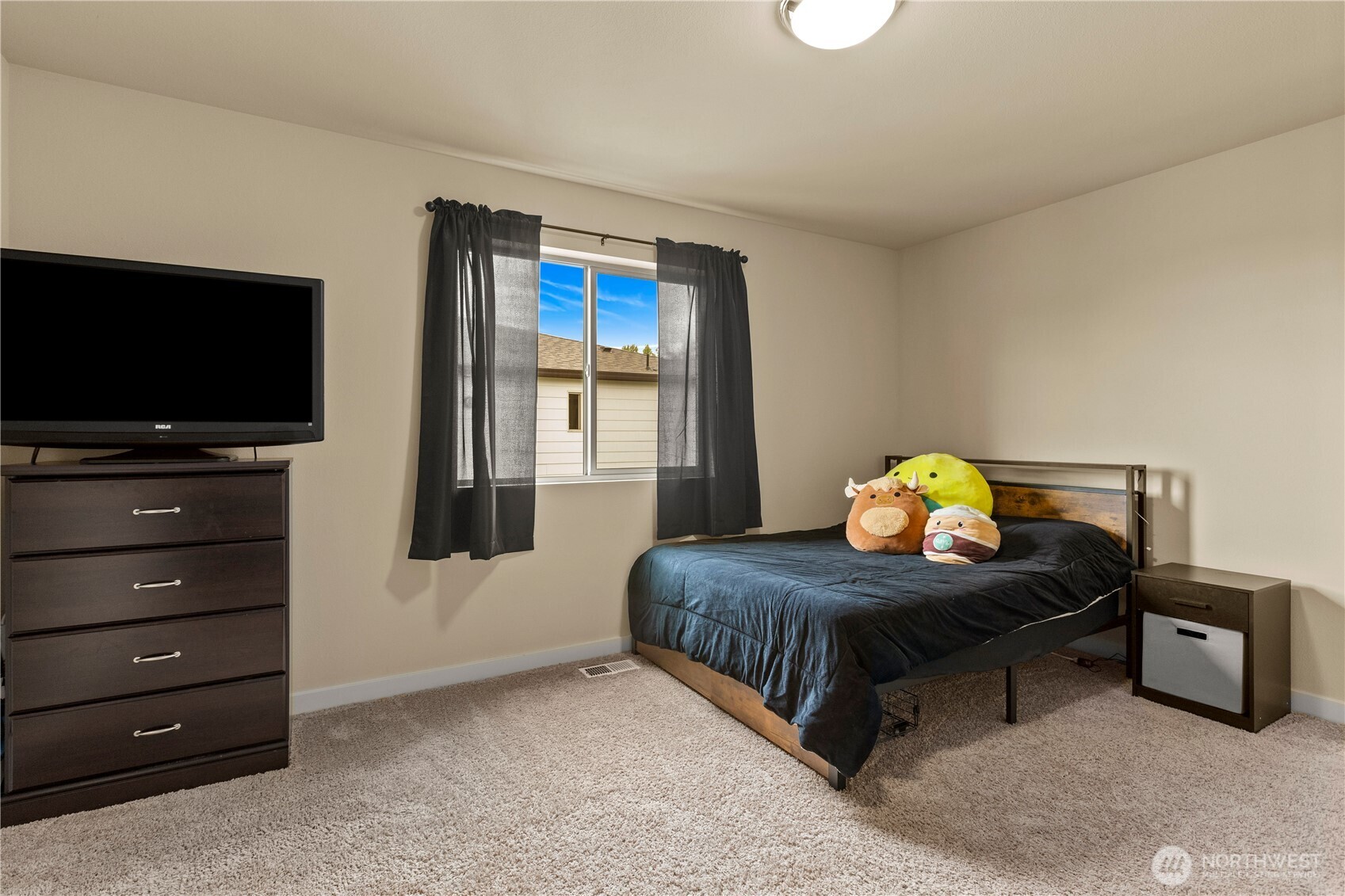 396 South Sergeant Street Buckley, WA 98321 - Photo 24 of 39 a bedroom with a bed and a flat tv screen on dresser