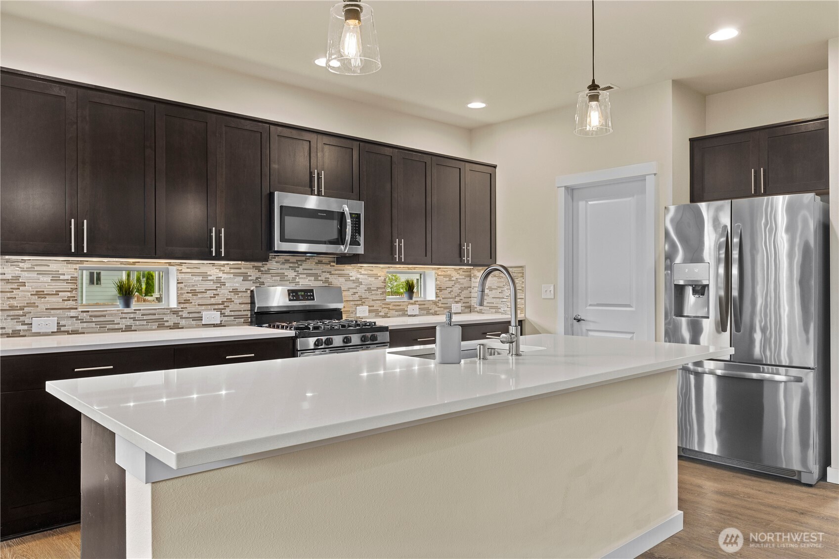 396 South Sergeant Street Buckley, WA 98321 - Photo 7 of 39 a kitchen with kitchen island granite countertop stainless steel appliances a sink cabinets and a counter top space