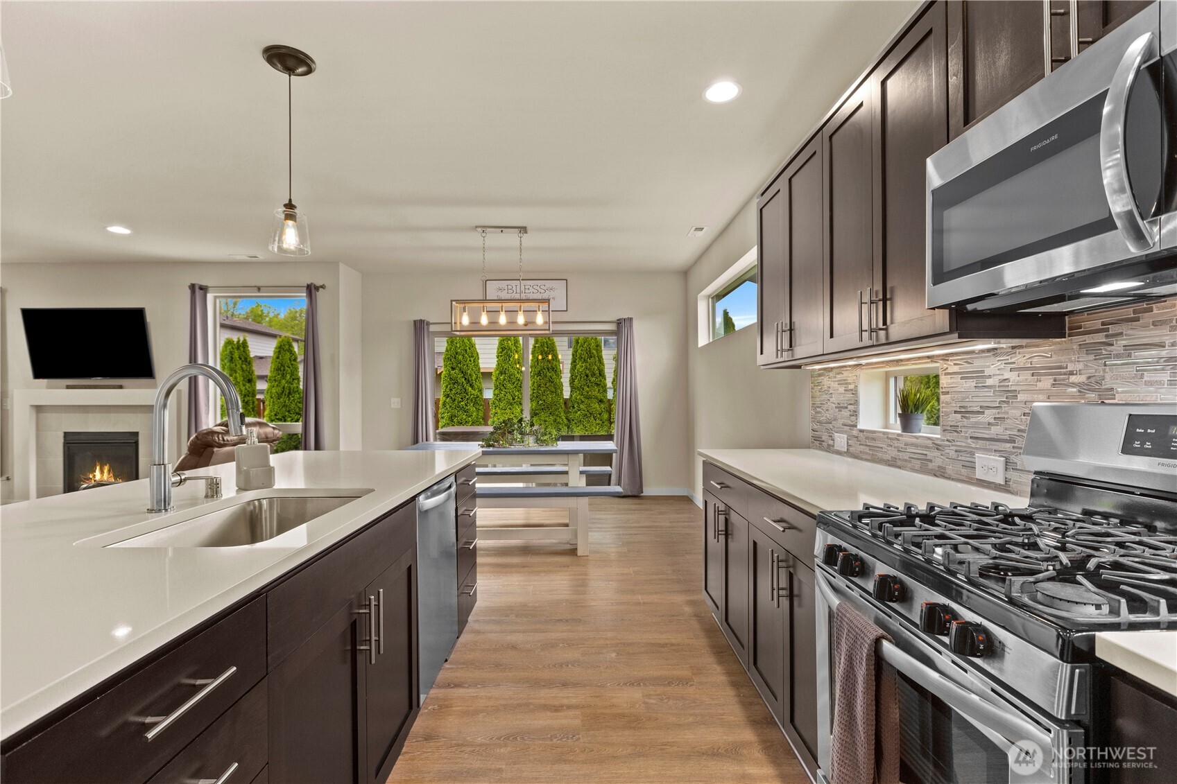 396 South Sergeant Street Buckley, WA 98321 - Photo 9 of 39 a kitchen with stainless steel appliances granite countertop a sink stove and cabinets