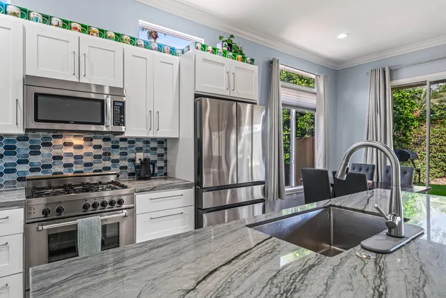 a kitchen with granite countertop a stove and a microwave oven