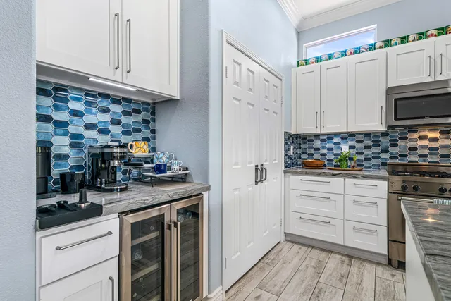 a kitchen with white cabinets and appliances